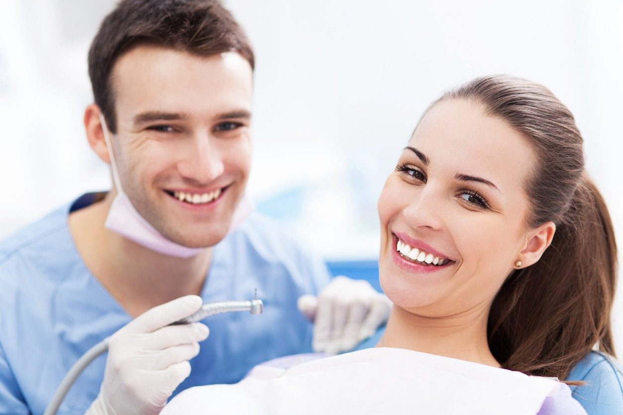 Happy patient smiling after treatment with her dentist